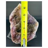 A vibrant Super 7 slice showcasing the unique combination of seven powerful minerals—amethyst, cacoxenite, goethite, lepidocrocite, rutile, smoky quartz, and clear quartz.