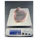 A vibrant Super 7 slice showcasing the unique combination of seven powerful minerals—amethyst, cacoxenite, goethite, lepidocrocite, rutile, smoky quartz, and clear quartz.