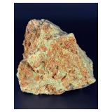 A delicate carbonate mineral of zinc and copper, displaying soft hues of pale blue to green‑blue in fine acicular (needle‑like) crystal sprays or tufted clusters.