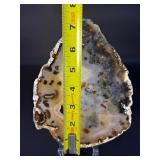 An Agate Slice (Raw) showcases the natural beauty of agate in its most organic form.