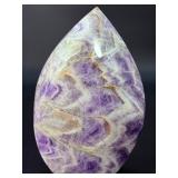 A Chevron Amethyst Freeform is a beautiful, naturally shaped crystal that features striking V-shaped banding of deep purple amethyst and milky white quartz. Also known as Dream Amethyst,