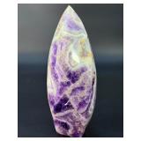 A Chevron Amethyst Freeform is a beautiful, naturally shaped crystal that features striking V-shaped banding of deep purple amethyst and milky white quartz. Also known as Dream Amethyst,