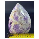 A Chevron Amethyst Freeform is a beautiful, naturally shaped crystal that features striking V-shaped banding of deep purple amethyst and milky white quartz. Also known as Dream Amethyst,