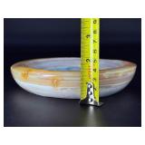 Agate dish is a beautifully polished, hand-carved piece that highlights the natural banding and rich earthy tones of agate.