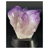 An Elestial Amethyst Cluster is a rare and powerful crystal formation celebrated for its intricate, layered growth and deep spiritual energy.