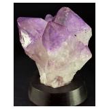 An Elestial Amethyst Cluster is a rare and powerful crystal formation celebrated for its intricate, layered growth and deep spiritual energy.
