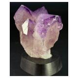 An Elestial Amethyst Cluster is a rare and powerful crystal formation celebrated for its intricate, layered growth and deep spiritual energy.