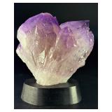 An Elestial Amethyst Cluster is a rare and powerful crystal formation celebrated for its intricate, layered growth and deep spiritual energy.
