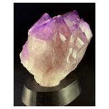 An Elestial Amethyst Cluster is a rare and powerful crystal formation celebrated for its intricate, layered growth and deep spiritual energy.