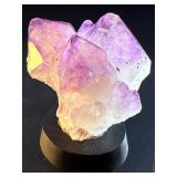 An Elestial Amethyst Cluster is a rare and powerful crystal formation celebrated for its intricate, layered growth and deep spiritual energy.