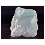 A Blue Raw Fluorite piece showcases the crystal in its natural, unpolished state, highlighting its geometric formations and soft to vibrant blue hues.