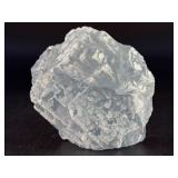 A Blue Raw Fluorite piece showcases the crystal in its natural, unpolished state, highlighting its geometric formations and soft to vibrant blue hues.