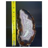 Banded Amethyst Agate (Polished) is a stunning crystal piece that combines the deep, rich purples of amethyst with the layered, earthy tones of agate.