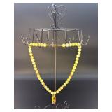 This is a beautifully crafted piece that blends the warm, golden tones of honey calcite with symbolic spiritual energy. The Gyan Mudra hand charm representing wisdom and spiritual connection.