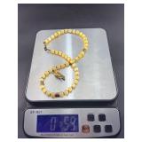 This is a beautifully crafted piece that blends the warm, golden tones of honey calcite with symbolic spiritual energy. The Gyan Mudra hand charm representing wisdom and spiritual connection.