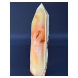 Carnelian Flower Agate Tower is a stunning hand-carved crystal that combines the vibrant, energizing hues of carnelian with the earthy, patterned beauty of flower agate.