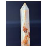 Carnelian Flower Agate Tower is a stunning hand-carved crystal that combines the vibrant, energizing hues of carnelian with the earthy, patterned beauty of flower agate.