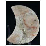 Pink Druzy Amethyst Moon is a stunning crescent-shaped crystal featuring a sparkling druzy surface in soft pink and delicate amethyst tones.