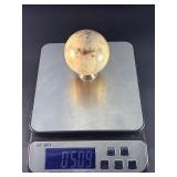 Moonstone Sphere with Blue Flashes is a captivating crystal sphere known for its soft, luminous glow and stunning blue flashes that shimmer as the light moves across its surface.