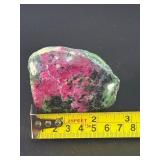 Ruby Zoisite is a striking natural stone that beautifully blends vibrant ruby inclusions with earthy green zoisite, often accented by dark hornblende veins.