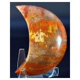 Petrified Wood Moon is a beautifully carved piece that captures ancient earth energy in a graceful moon shape.
