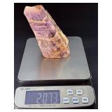 Raw Chevron Amethyst showcases the stone in its natural, unpolished form, highlighting bold V-shaped bands of deep purple amethyst and milky white quartz.