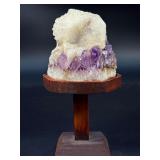 Amethyst Geode with Calcite is a stunning natural formation that combines sparkling amethyst crystals with contrasting calcite inclusions.