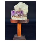 Amethyst Geode with Calcite is a stunning natural formation that combines sparkling amethyst crystals with contrasting calcite inclusions.
