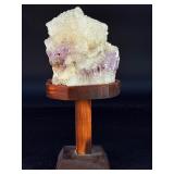 Amethyst Geode with Calcite is a stunning natural formation that combines sparkling amethyst crystals with contrasting calcite inclusions.