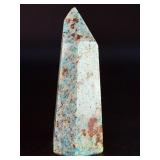 Amazonite Tower is a beautifully polished crystal tower that showcases the soothing, turquoise-green hues of amazonite, often accented with natural striations and subtle white veining.