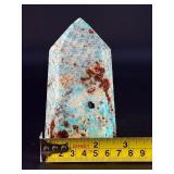 Amazonite Tower is a beautifully polished crystal tower that showcases the soothing, turquoise-green hues of amazonite, often accented with natural striations and subtle white veining.