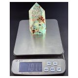 Amazonite Tower is a beautifully polished crystal tower that showcases the soothing, turquoise-green hues of amazonite, often accented with natural striations and subtle white veining.