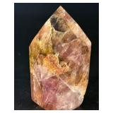 Super 7 Tower is a powerful and highly sought-after crystal carved into a polished towerthat showcases the natural blend of seven minerals: amethyst, clear quartz, smokyquartz, rutile, goethite, lepid