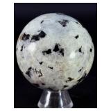 Rainbow Moonstone Sphere is a luminous and enchanting crystal sphere known for its soft glow and mesmerizing flashes of blue, rainbow, and pearly light that shimmer as it moves.