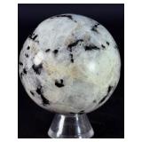 Rainbow Moonstone Sphere is a luminous and enchanting crystal sphere known for its soft glow and mesmerizing flashes of blue, rainbow, and pearly light that shimmer as it moves.