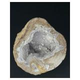 Natural Quartz Agate “Galaxy” Geode is a mesmerizing geological treasure that resembles a miniature cosmic landscape.