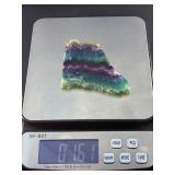 Rainbow Fluorite Slab is a stunning, polished slice that showcases fluorite’s signature bands of purple, green, blue, and soft teal hues.