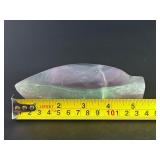 Fluorite Leaf Dish is a hand-carved crystal piece shaped like a delicate leaf bowl, showcasing the natural banding and vibrant colors of fluorite.