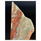 Crazy Lace Agate is a vibrant and eye-catching crystal known for its intricate, swirling patterns and lively mix of colors, typically including creamy whites, warm reds, oranges, and browns.