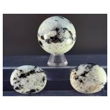 Rainbow Moonstone Sphere and Palm Stones are enchanting pieces that showcase the soft, luminous glow and signature flashes of rainbow sheen unique to rainbow moonstone.