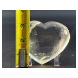 Natural Clear Quartz Puffy Heart with inclusions is a charming, hand-polished crystal carved into a soft, rounded heart shape.