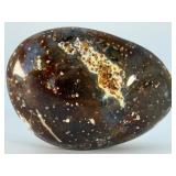 Orbs Ocean Jasper Palm Stone is a smooth, hand-polished crystal shaped to fit comfortably in the palm, showcasing the signature orb-like patterns and soothing earthy tones of ocean jasper.