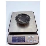 Orthoceras Fossil Bowl is a striking, hand-carved display piece featuring the elongated, jet-black orthoceras fossils embedded in a smooth, polished matrix.