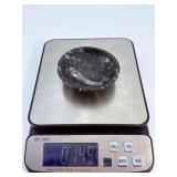 Orthoceras Fossil Bowl is a striking, hand-carved display piece featuring the elongated, jet-black orthoceras fossils embedded in a smooth, polished matrix.