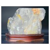 A radiant Golden Healer quartz that shimmers with warm, honey-gold hues and soft natural phantoms.  with custom wooden stand from Brazil