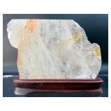 A radiant Golden Healer quartz that shimmers with warm, honey-gold hues and soft natural phantoms.  with custom wooden stand from Brazil