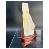 A radiant Golden Healer quartz that shimmers with warm, honey-gold hues and soft natural phantoms.  with custom wooden stand from Brazil