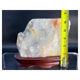 A radiant Golden Healer quartz that shimmers with warm, honey-gold hues and soft natural phantoms.  with custom wooden stand from Brazil