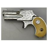 Misc. Vintage Miniature Cap Guns Two Break Open Pistols With Cow Adorned Handles And One Derringer (Missing Hammer)