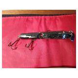 Vintage wooden jointed body Musky fishing lure and a plastic large minnow lure